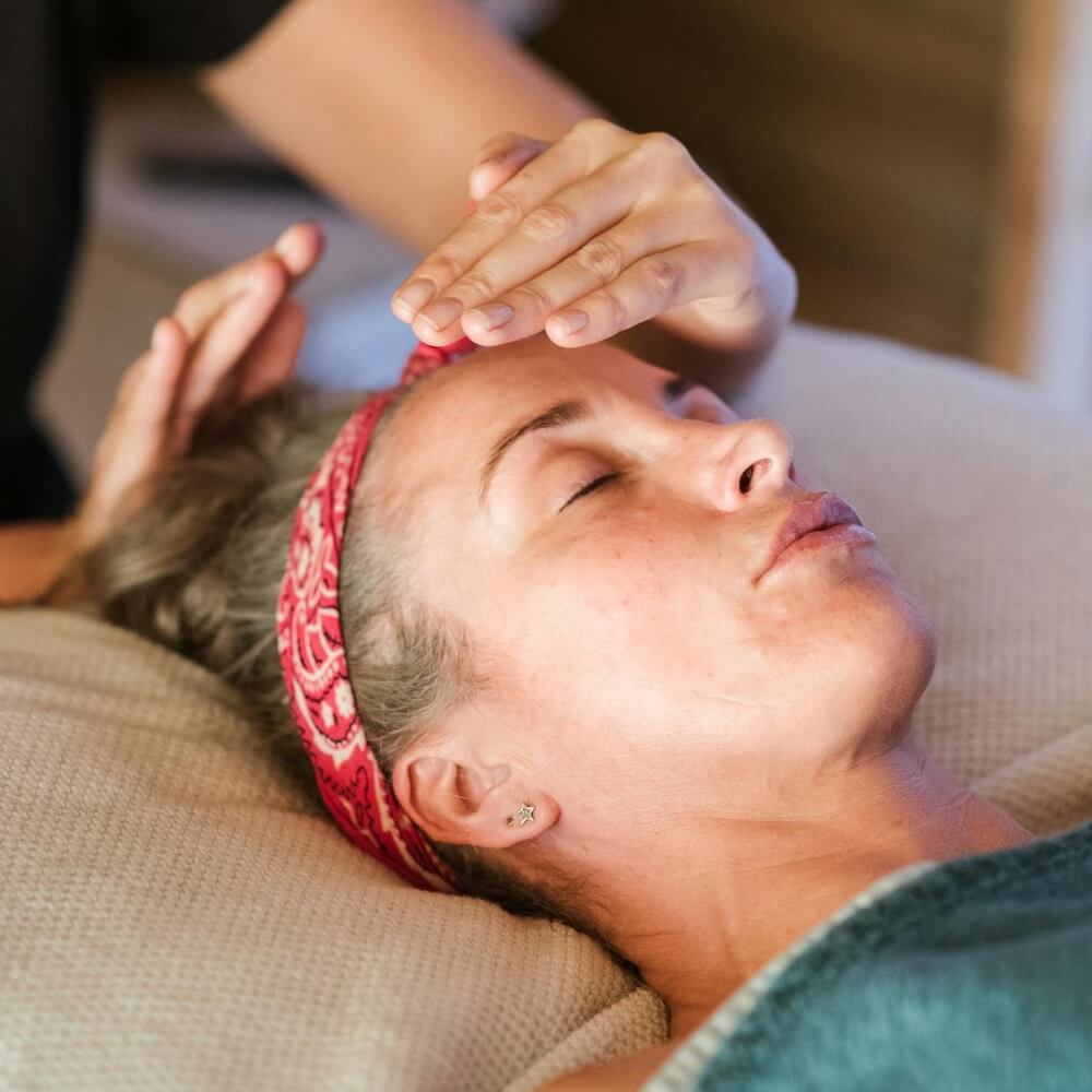 A practitioner sending reiki energy to a patient