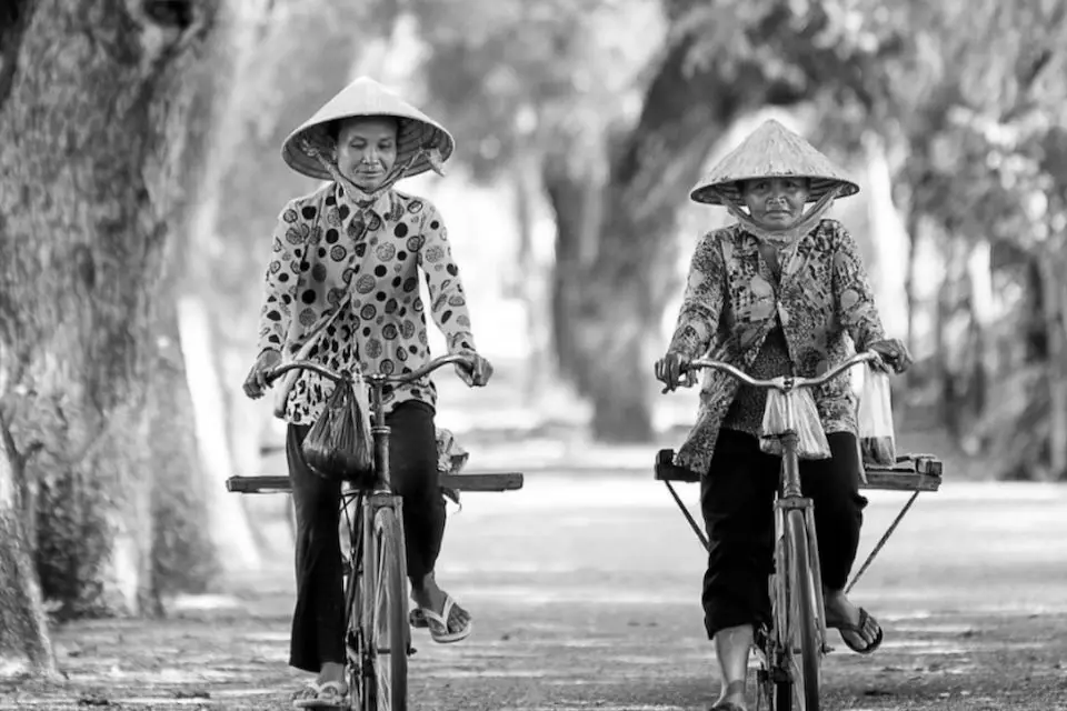 Villagers cycling on the road Villagers cycling on the road