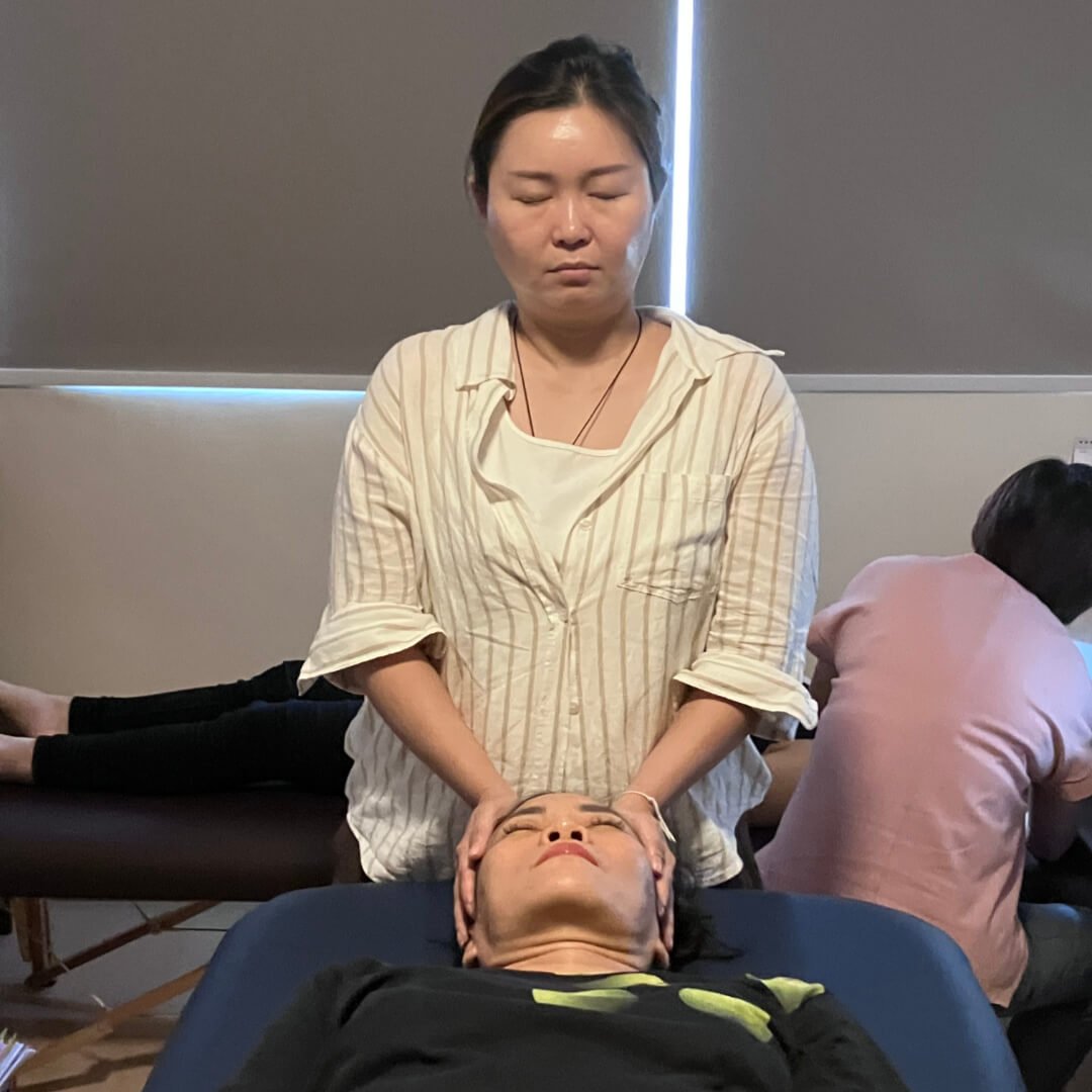 Students of Reiki 1 workshop on 14 Jun 2025 practicing reiki on each other