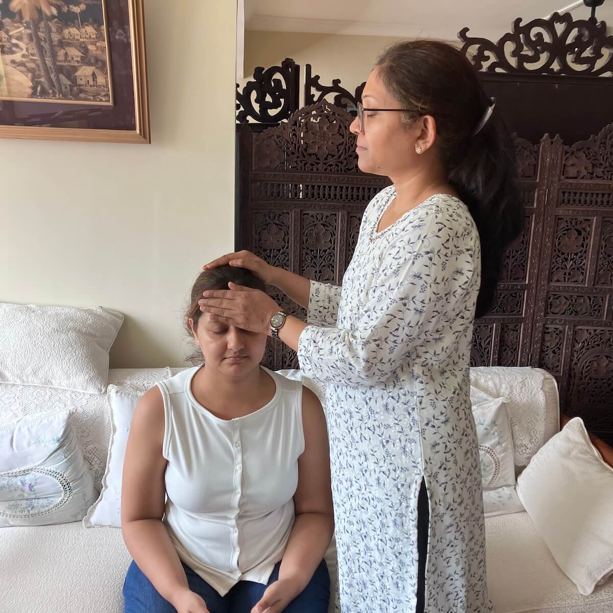 Students of Reiki 2 workshop on 26 Jul 2025 practicing reiki with Reiki 2 symbols on each other