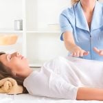 A woman receiving reiki healing