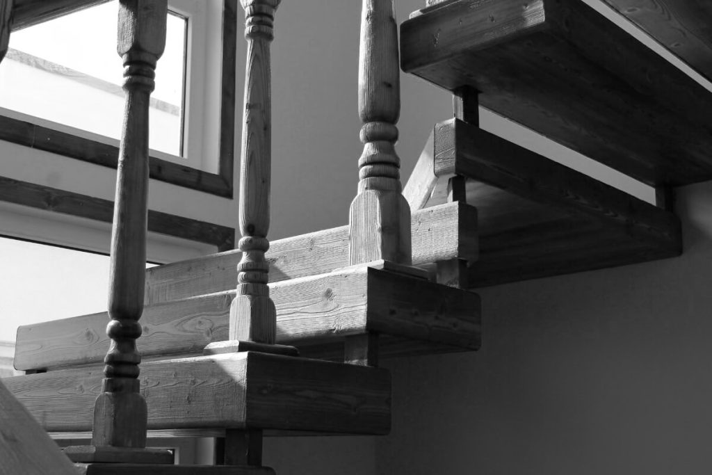 A mother pushes her boy down the stairs